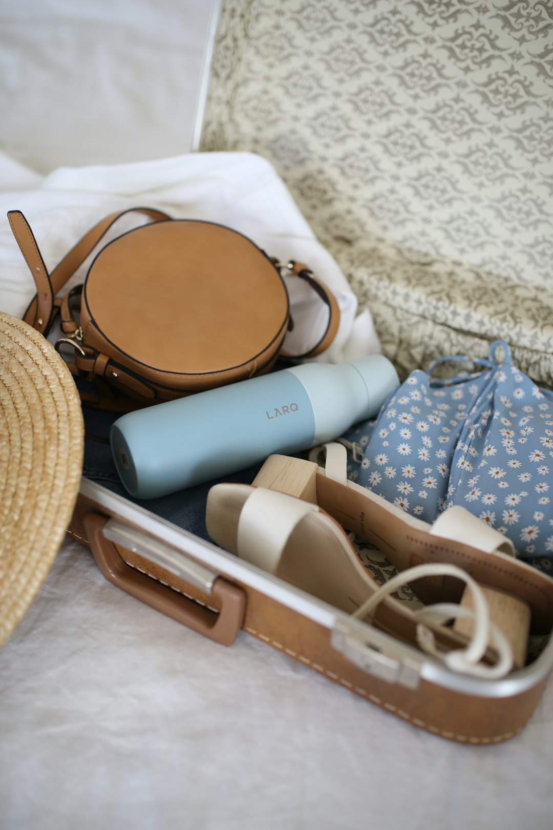 Reusable travel items including water bottle, utensils, and cloth bags
